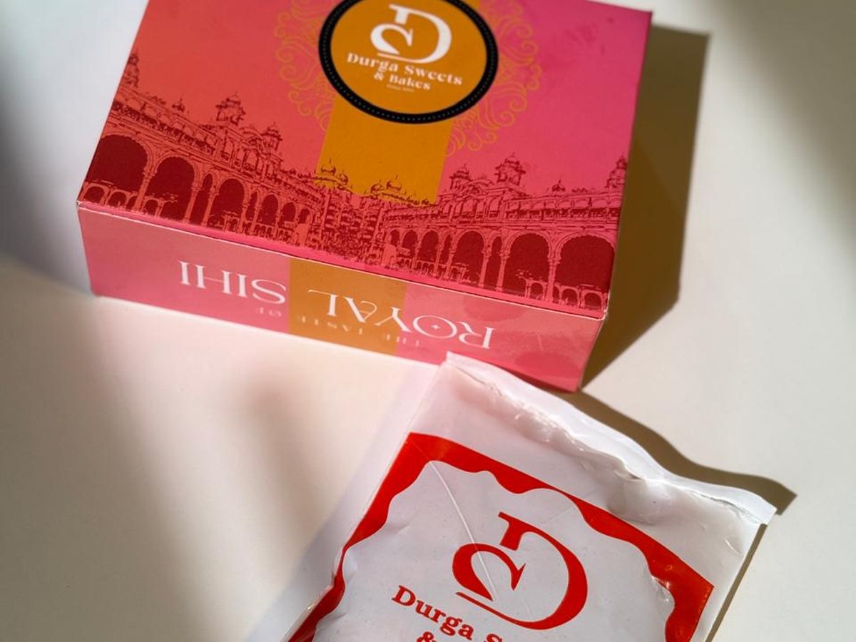 Royal Sihi gift box with a sealed Durga Sweets sweet packet